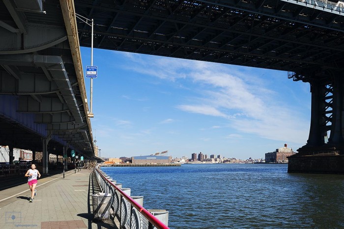 Jogger in Pink Shorts under Manhattan Bridge and East River, New York City
