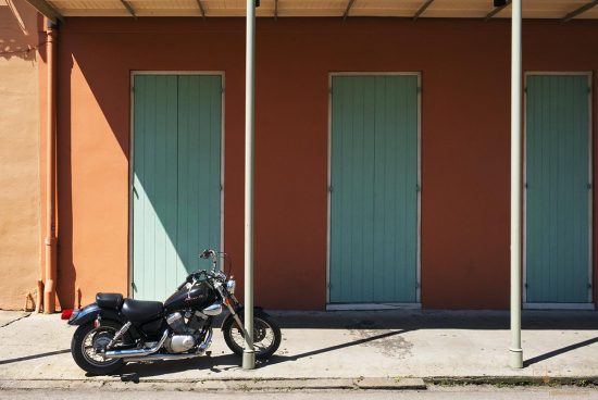 Black Star Motorcycle with Green Doors on Ursulines Avenue, New Orleans Black Star Motorcycle with Green Doors on Ursulines Avenue, New Orleans