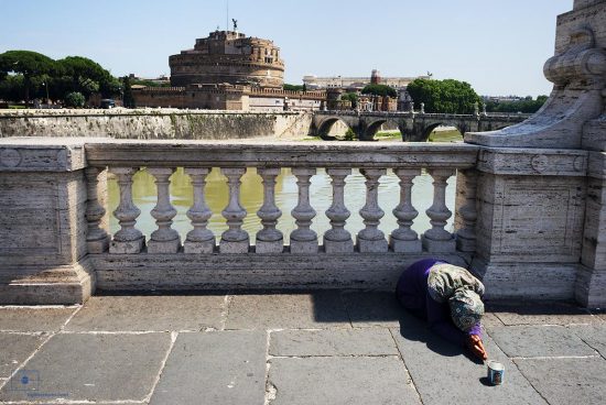 Mendicant on Ponte Vittorio Emanuele II and Tiber River, Rome Italy