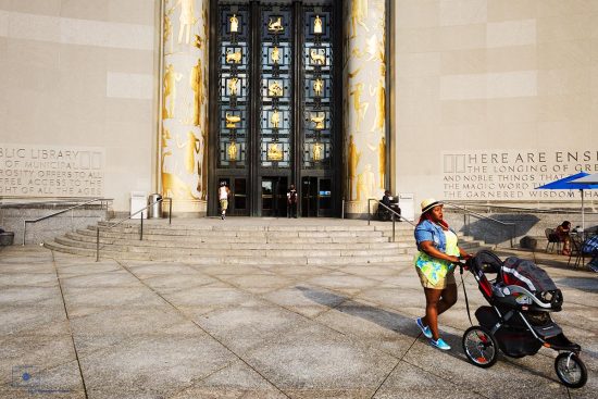 Mother and Stroller, Brooklyn, New York Mother with stroll in front of the Brooklyn Library in Grand Army Plaza, Brooklyn, New York