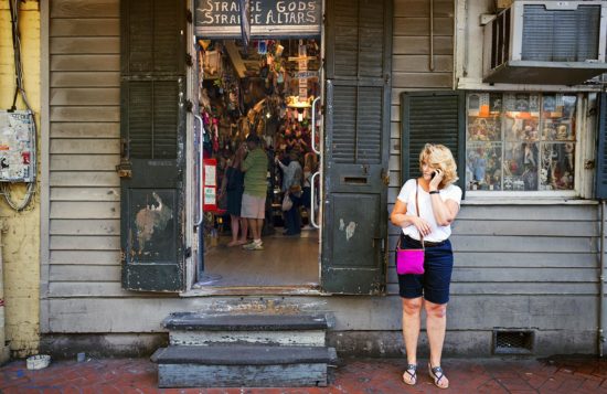 Woman on Phone with Voodoo Shop on Bourbon Street, New Orleans, Louisiana