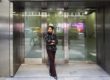 Woman with Earphones in Maroon and Brown - Midtown, New York City