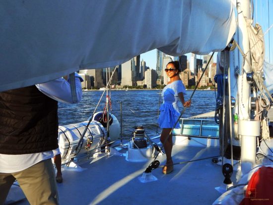 Harbor, New York City – Woman Posing and Financial District Woman on a Sailboat Posing with the Financial District in the Background - Harbor, New York City